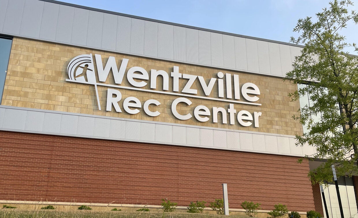 alt= A picture of the Wentzville Rec Center logo on the front of the WREC building.