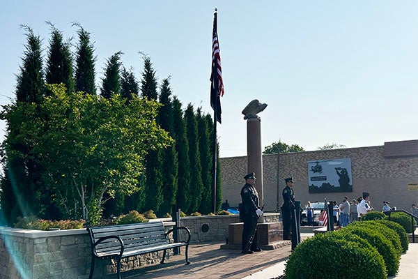Two soldiers standing near a memorial