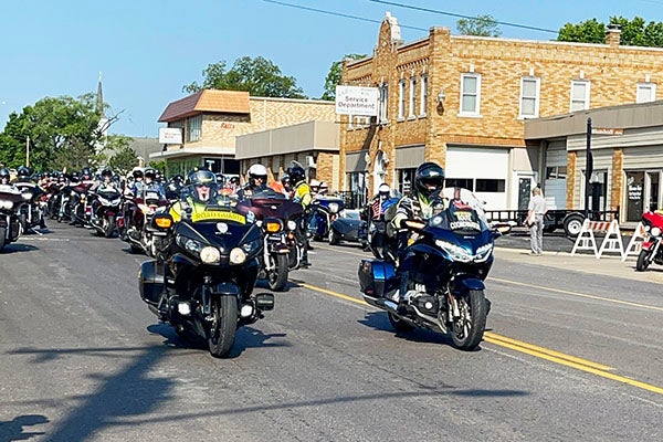 Motorcyclists driving down a road