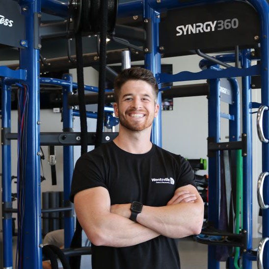 trainer Nick Maurer in front of gym equipment