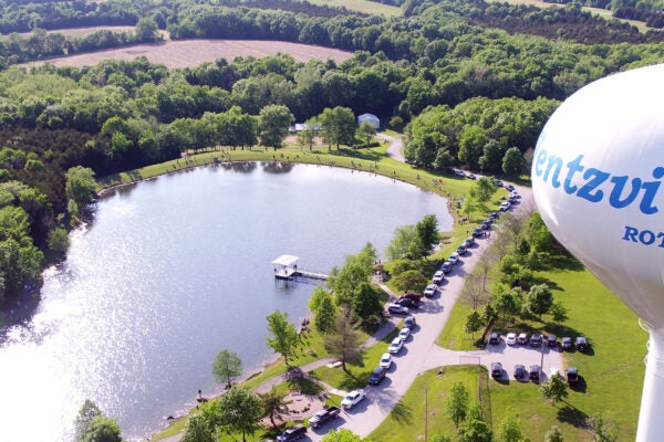 Ariel view of Rotary Park water tower, pond and parking. Walking path around pond
