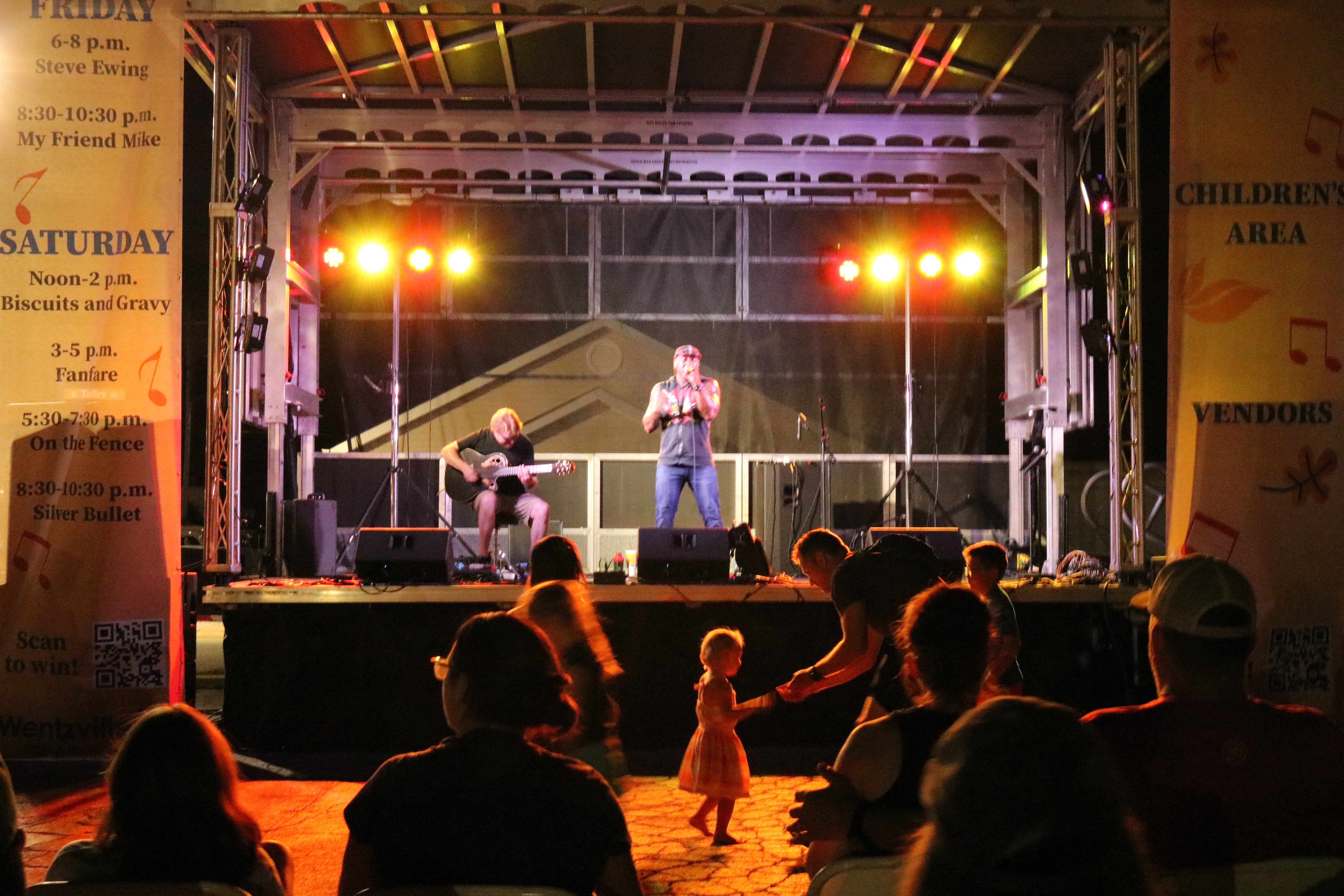 male singer on stage at night