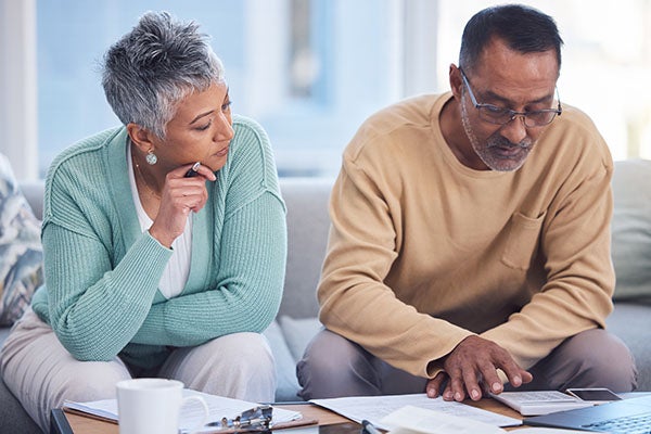 Two elderly people viewing documents