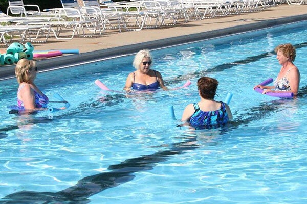Women do aerobic exercises in the pool