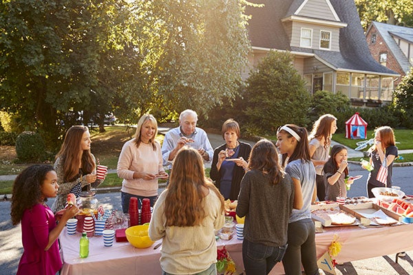 people surrounding a table with food