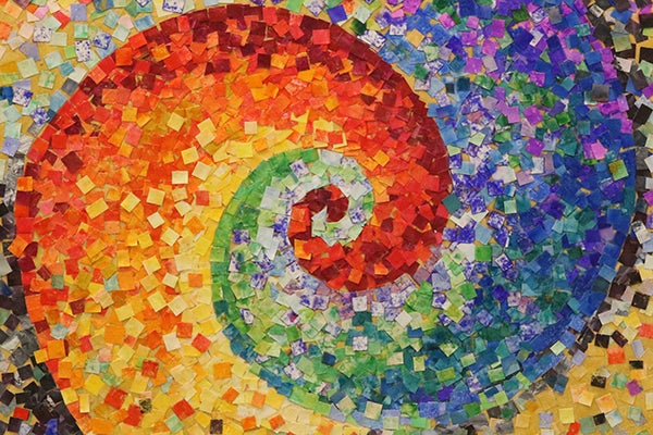 alt= A picture of a colorful swirl design made from small squares of paper.