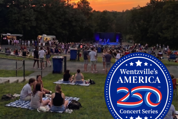 crowd of people watching an outdoor concert and sunset