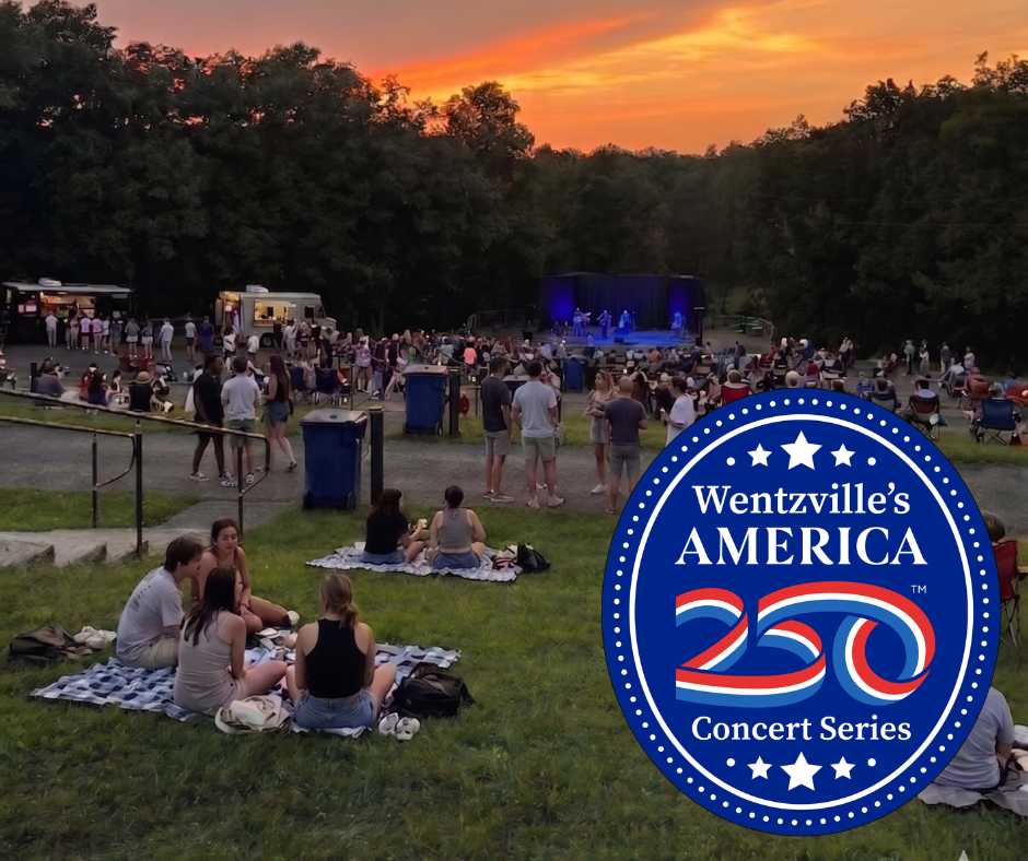 crowd of people watching an outdoor concert and sunset