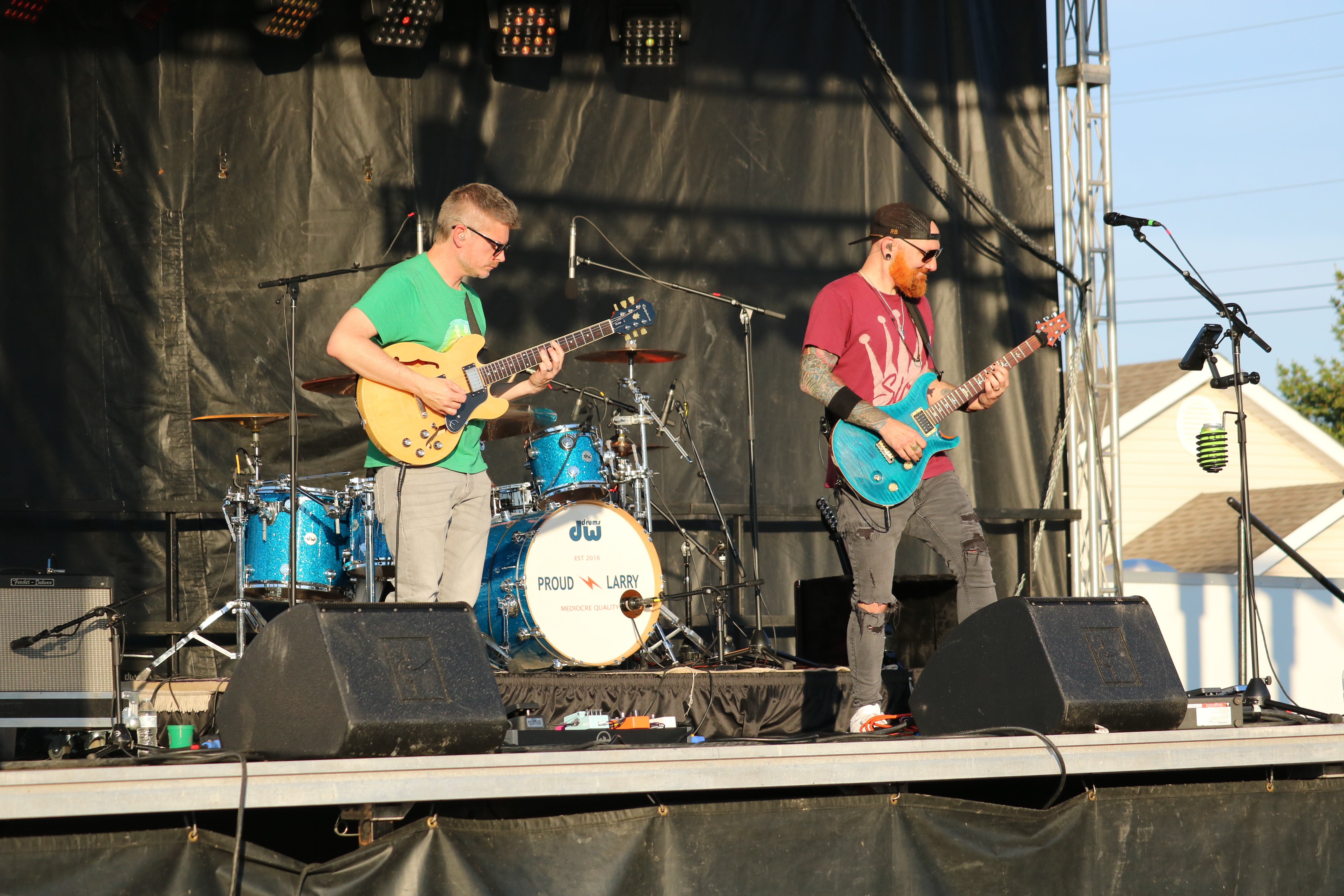 Two band members on stage at Wentzville Days playing guitar