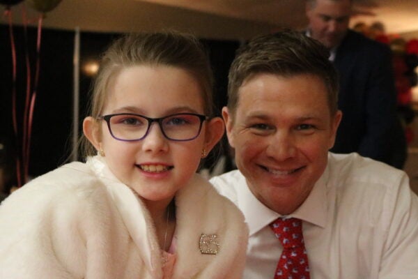 Father and daughter sitting at a table