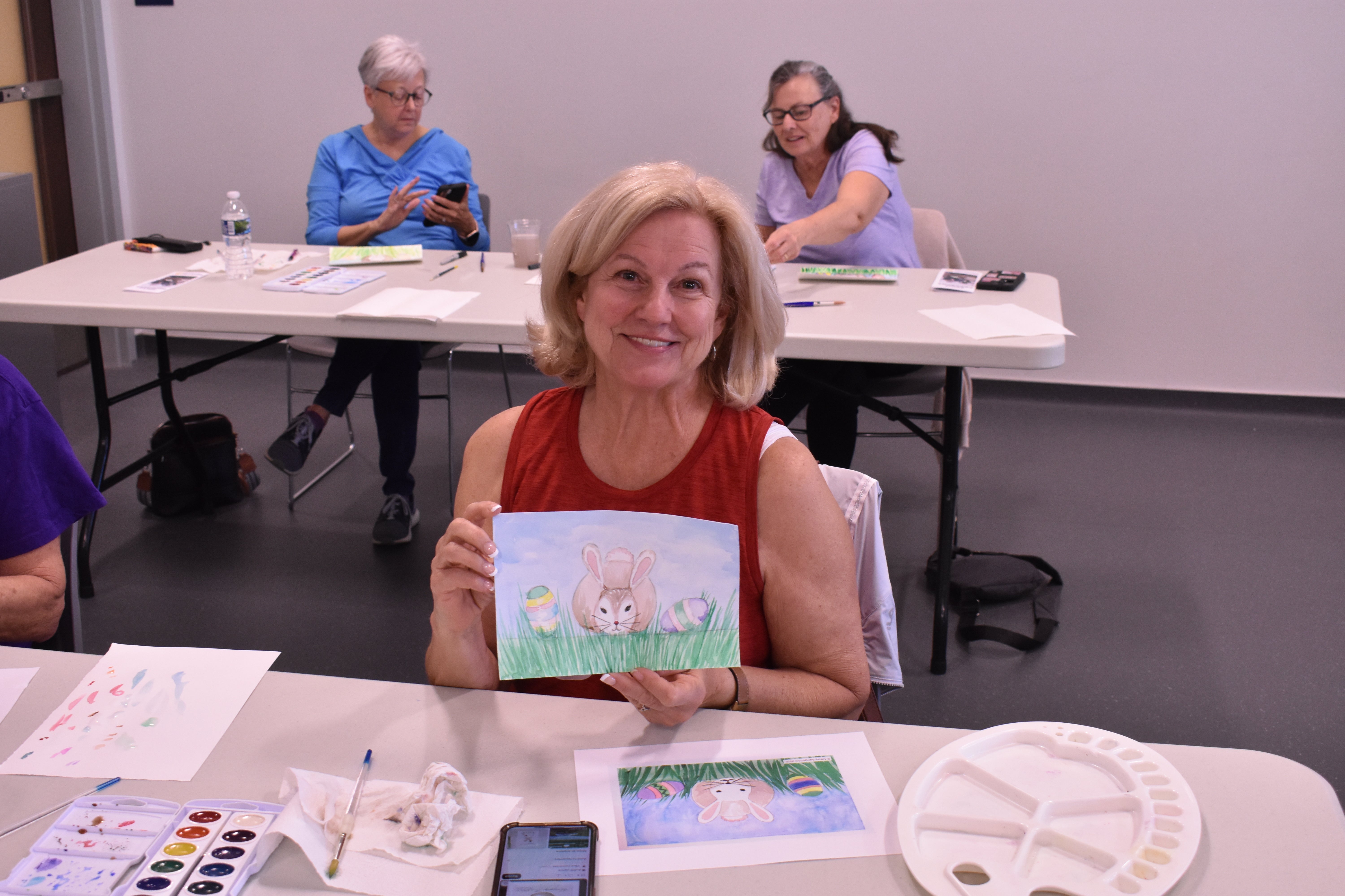 Woman holding watercolor painting