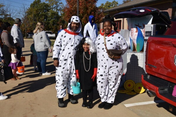 family dressed as Dalmatians and Cruella