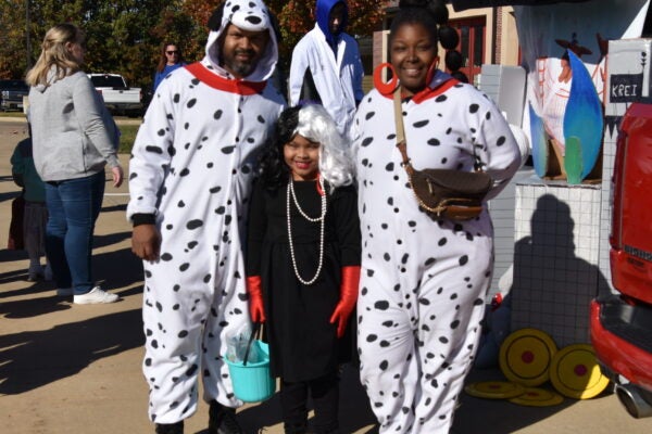 family dressed as Dalmatians and Cruella
