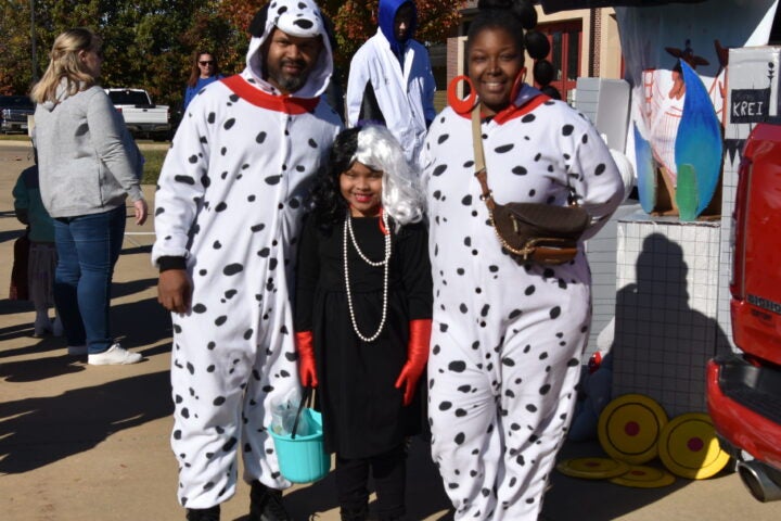 family dressed as Dalmatians and Cruella