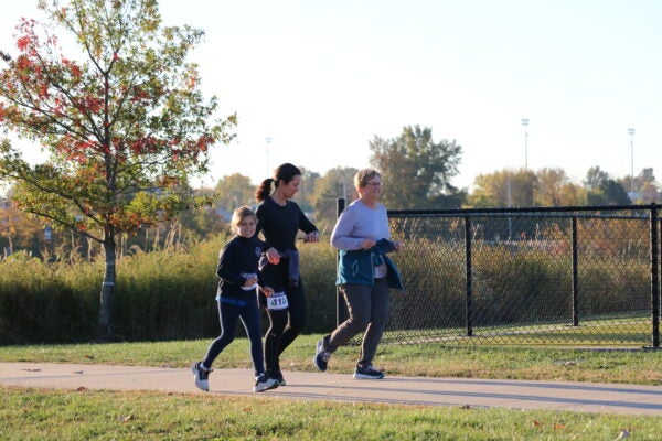 Two women and one girl running