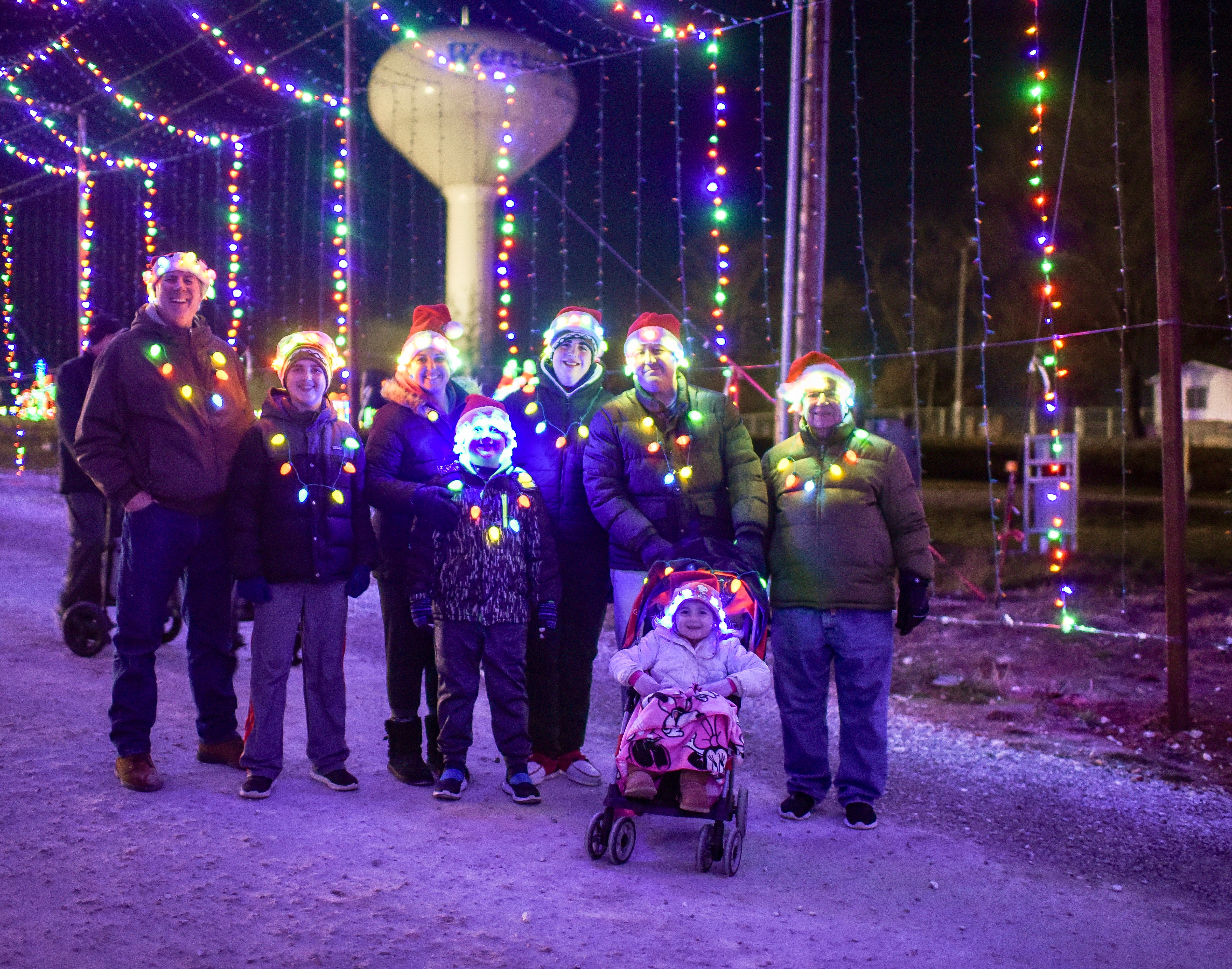 Family standing in front of a light display