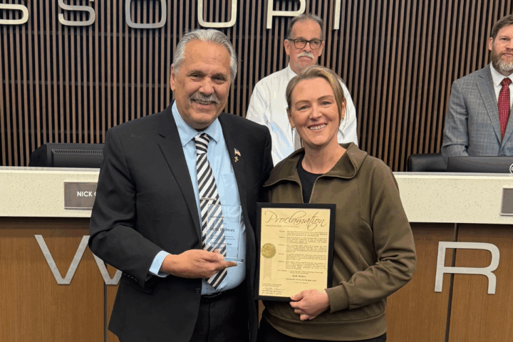 Mayor Nick Guccione presents Beth Wilmes with Citizen of the Year Award in front of the Board of Aldermen Dias int the Board Chamber at Wentzville City Hall.