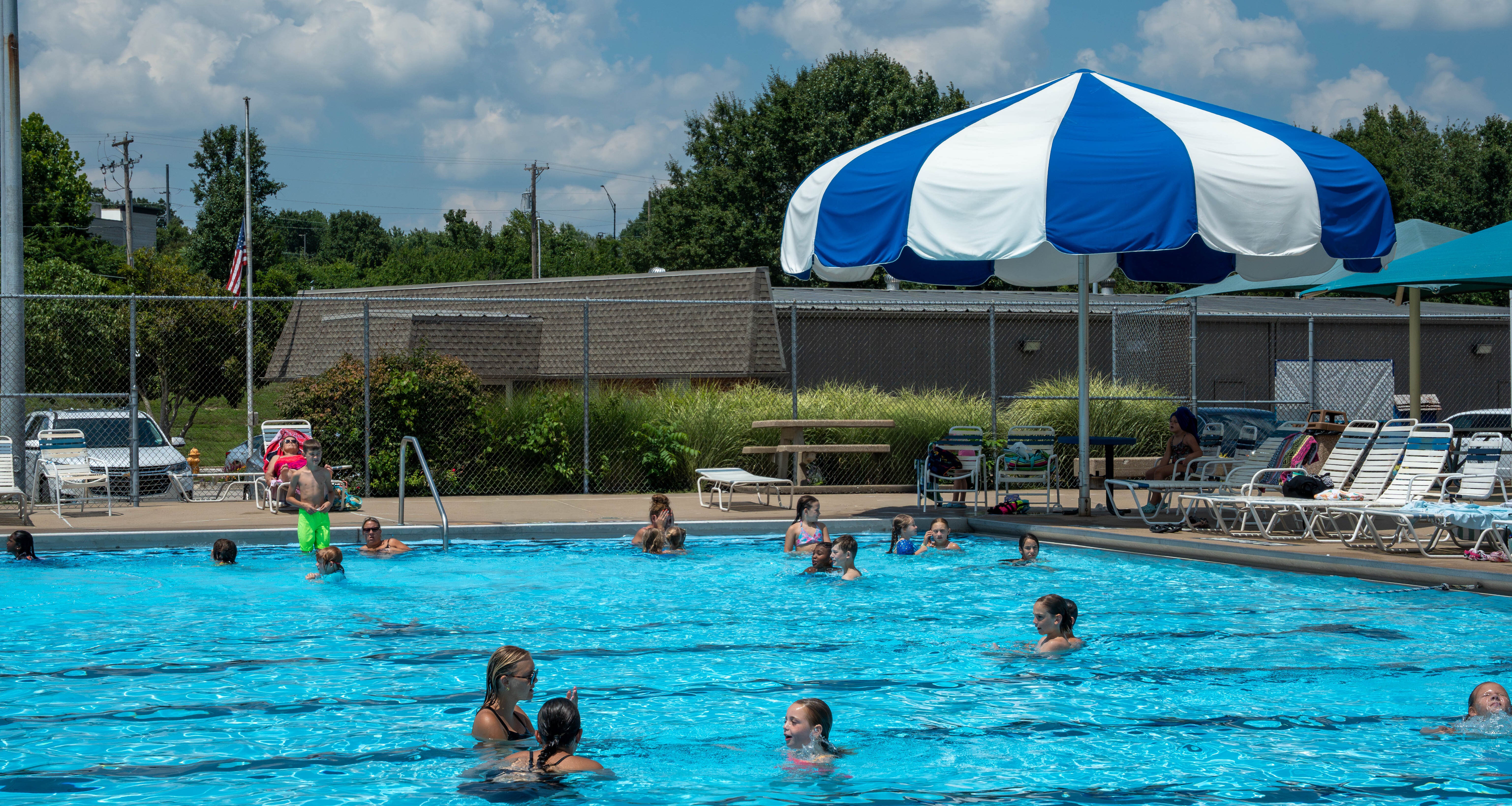 swimming pool with kids and families swimming